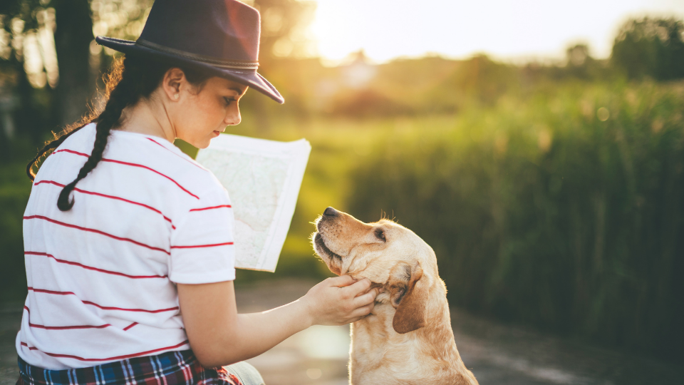 woman reading map with dog