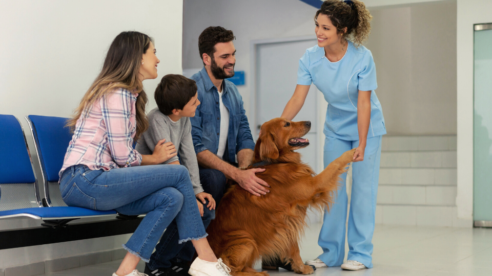 family at vet with dog