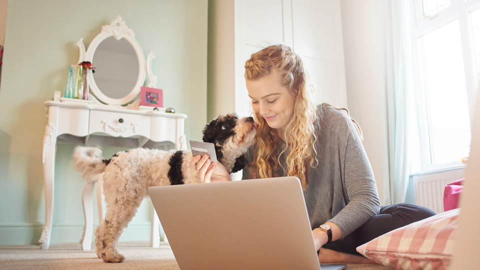 woman on computer next to dog