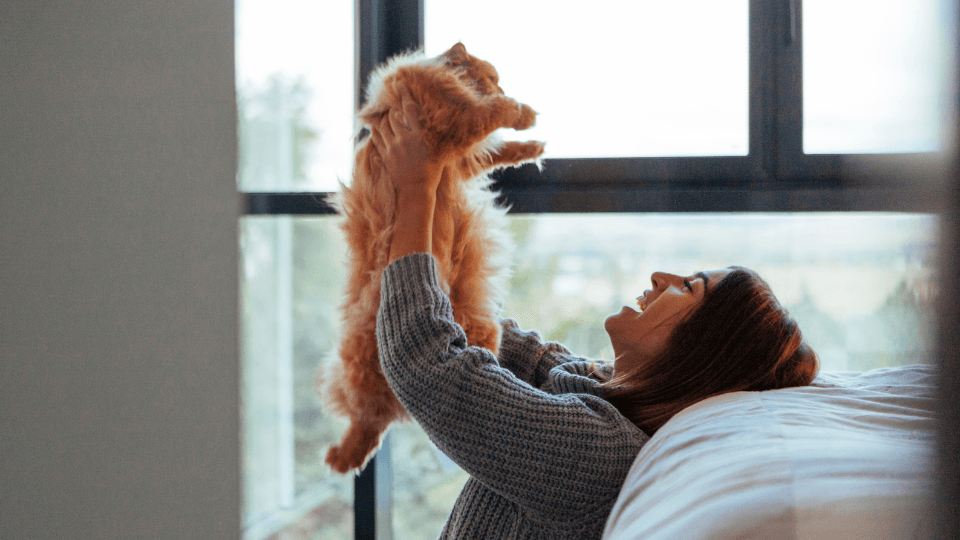 happy woman holding cat
