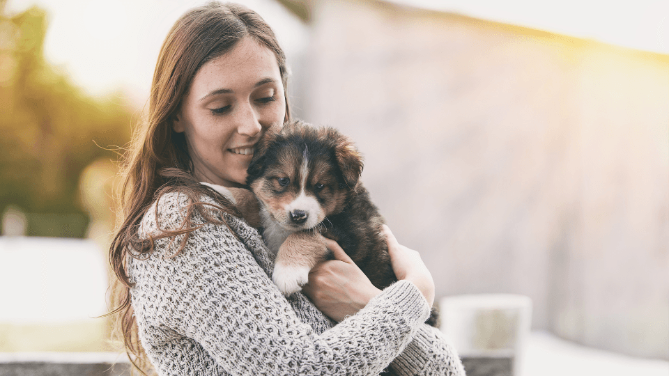 woman holding puppy