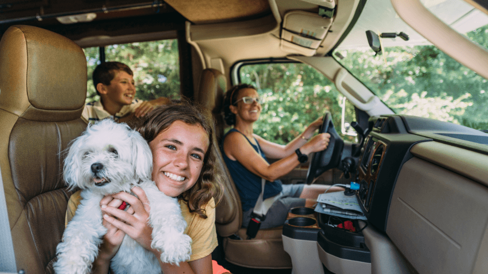 family and dog in rv