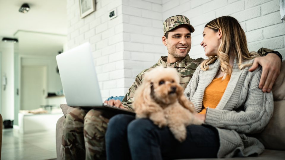 military couple sits with dog